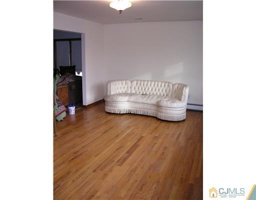 967 New Dover Road Edison, NJ 08820 - Photo 6 of 8 a bedroom with a bed and wooden floor