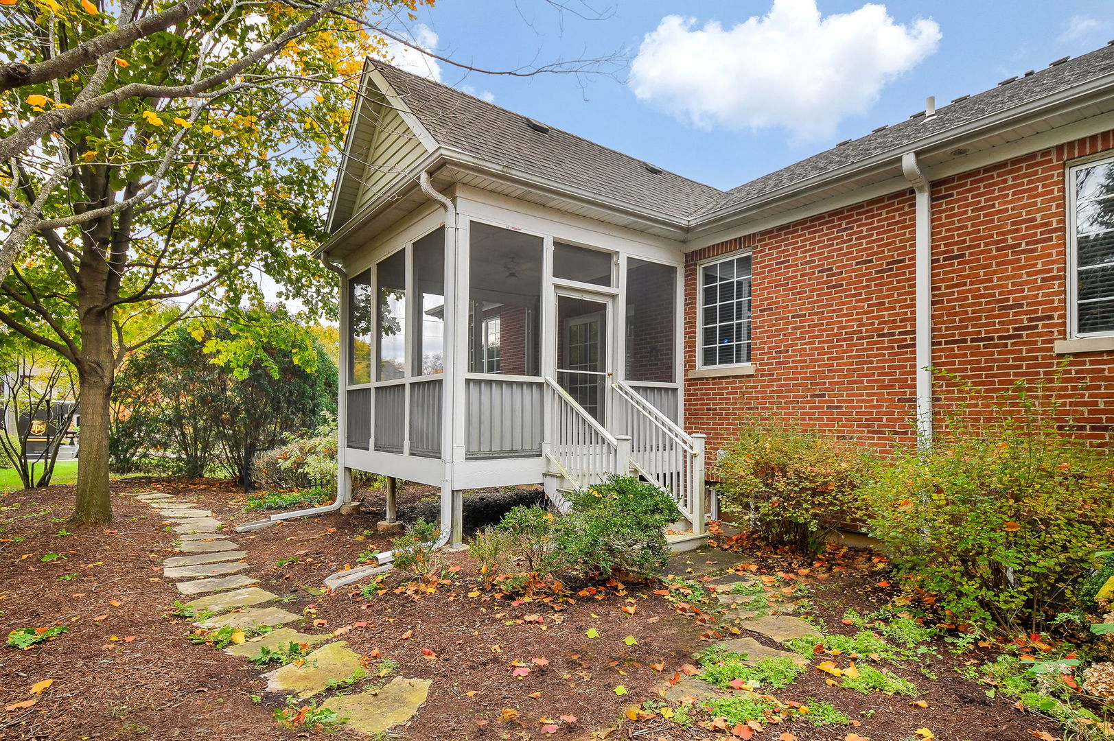 325 Delnor Glen Drive, Unit 325 St. Charles, IL 60174 - Photo 19 of 19 a brick house with large windows and plants