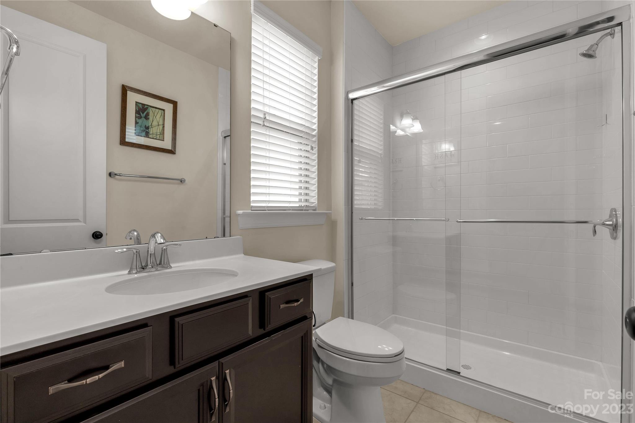 879 Pecan Tree Lane Fort Mill, SC 29715 - Photo 17 of 41 a bathroom with a sink a toilet and shower