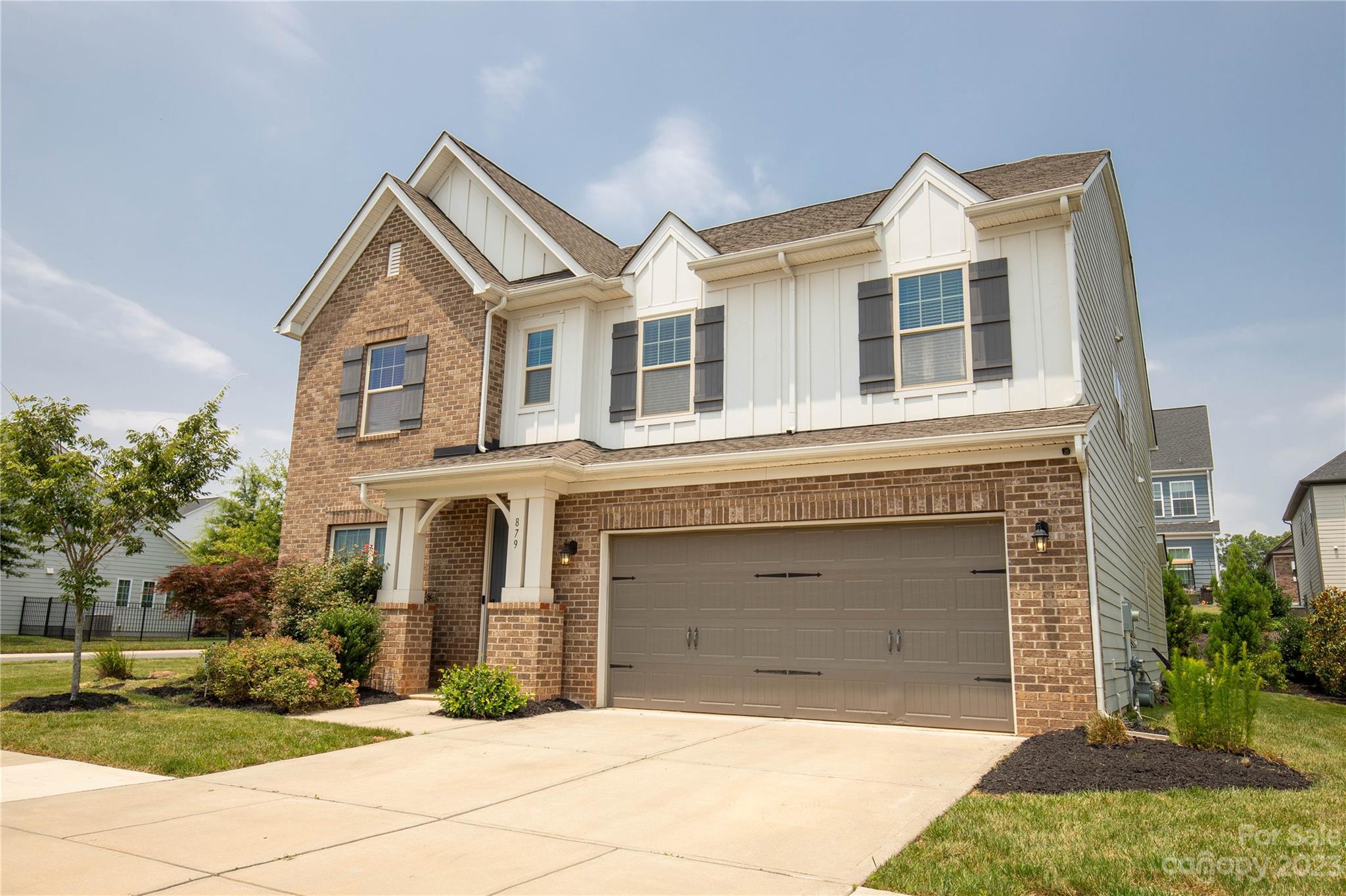 879 Pecan Tree Lane Fort Mill, SC 29715 - Photo 2 of 41 a front view of a house with a yard and garage