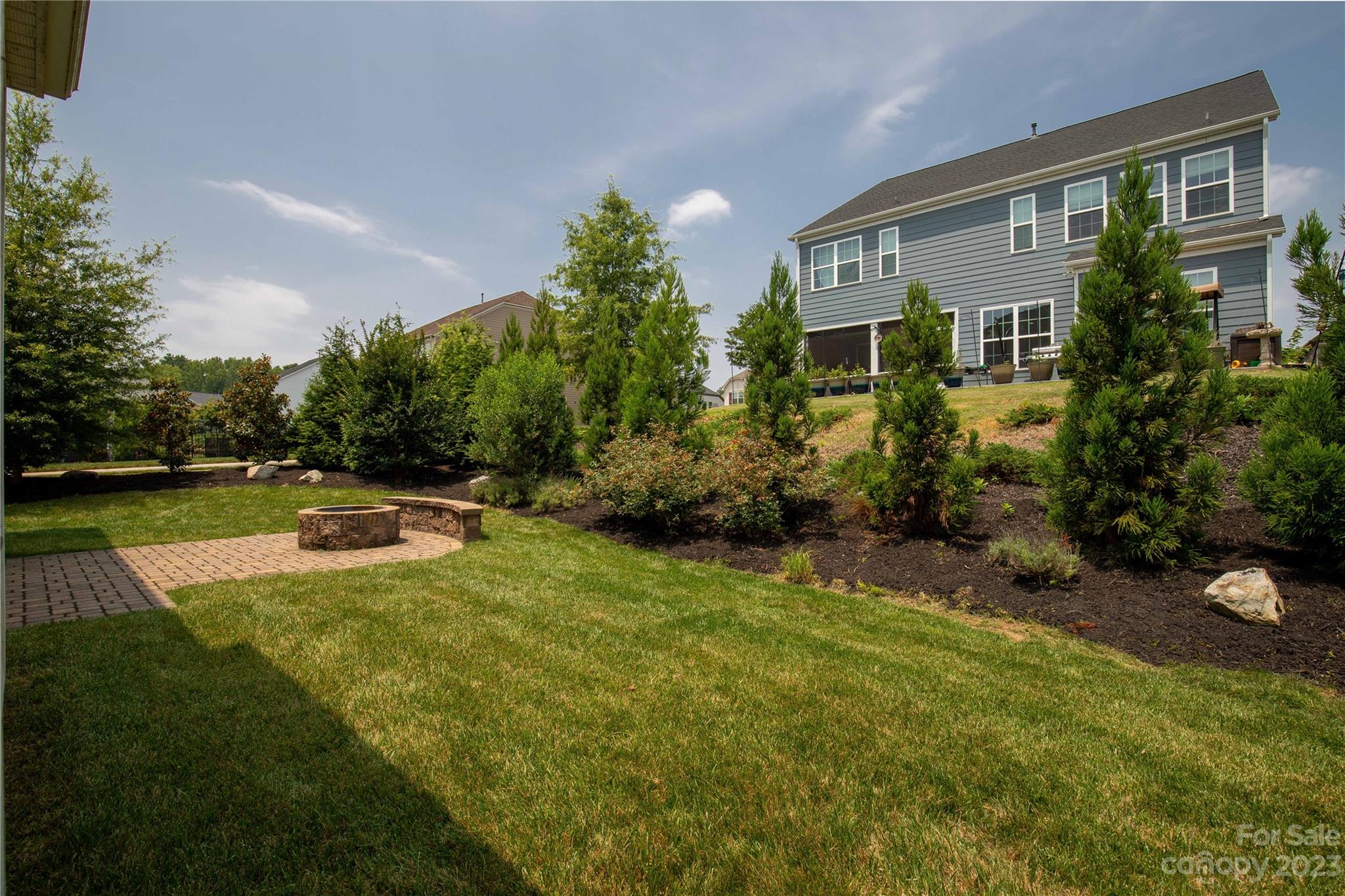 879 Pecan Tree Lane Fort Mill, SC 29715 - Photo 41 of 41 a view of a house with backyard sitting area and garden