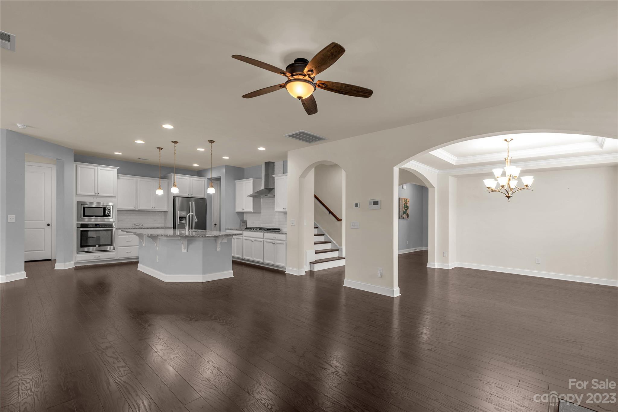 879 Pecan Tree Lane Fort Mill, SC 29715 - Photo 8 of 41 a view of a living room and kitchen with furniture wooden floor