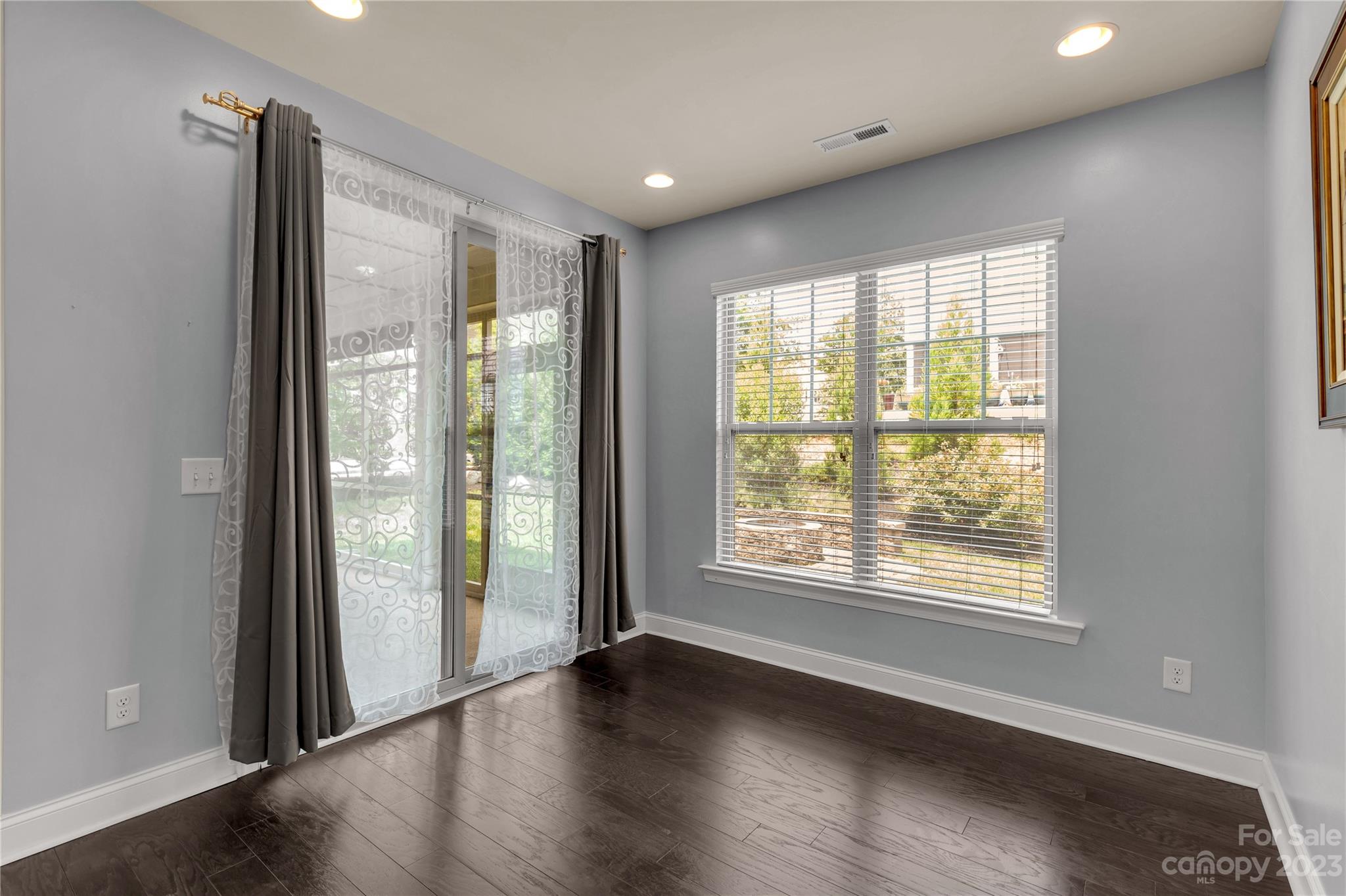 879 Pecan Tree Lane Fort Mill, SC 29715 - Photo 10 of 41 a view of an empty room with wooden floor and a window