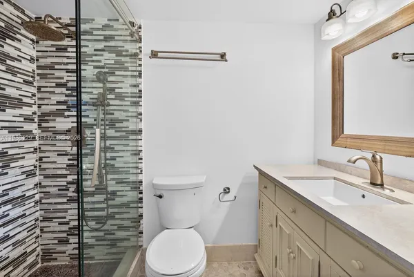 a bathroom with a sink toilet and shower