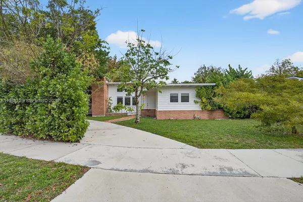 front view of a house next to a yard