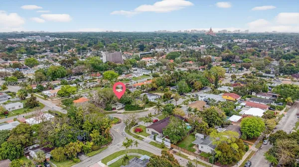 an aerial view of residential houses with cars parked