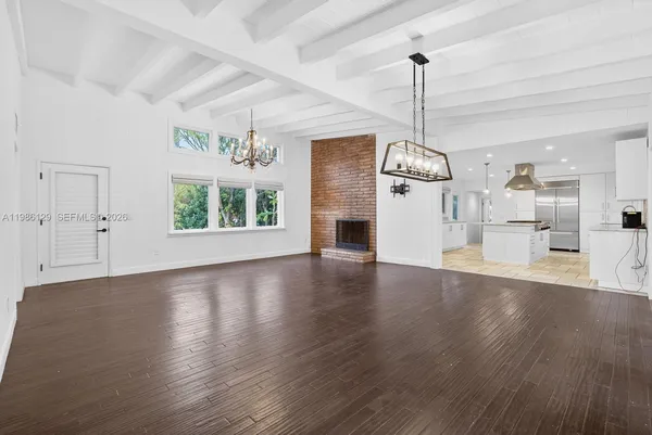 a view of a room with wooden floor windows and a chandelier