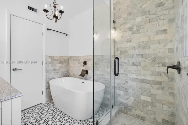 a bathroom with a bathtub and shower