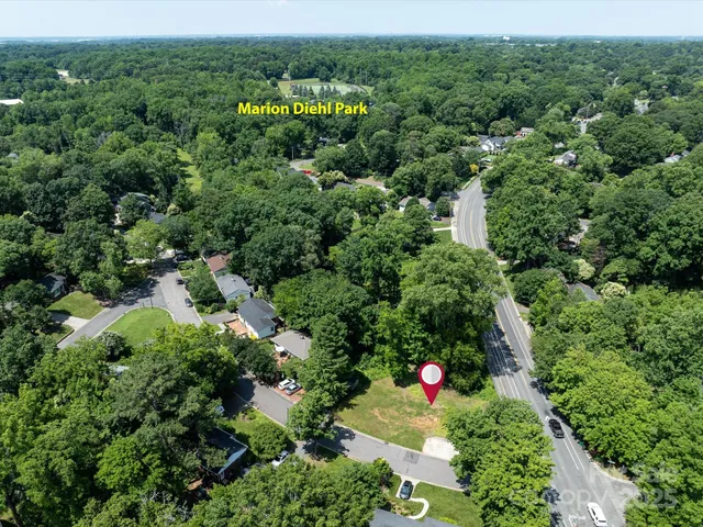 an aerial view of a house with swimming pool and garden