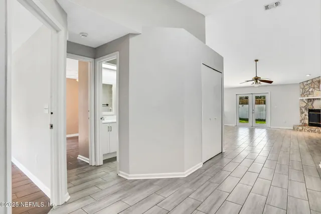 a view of empty room with a fireplace and wooden floor
