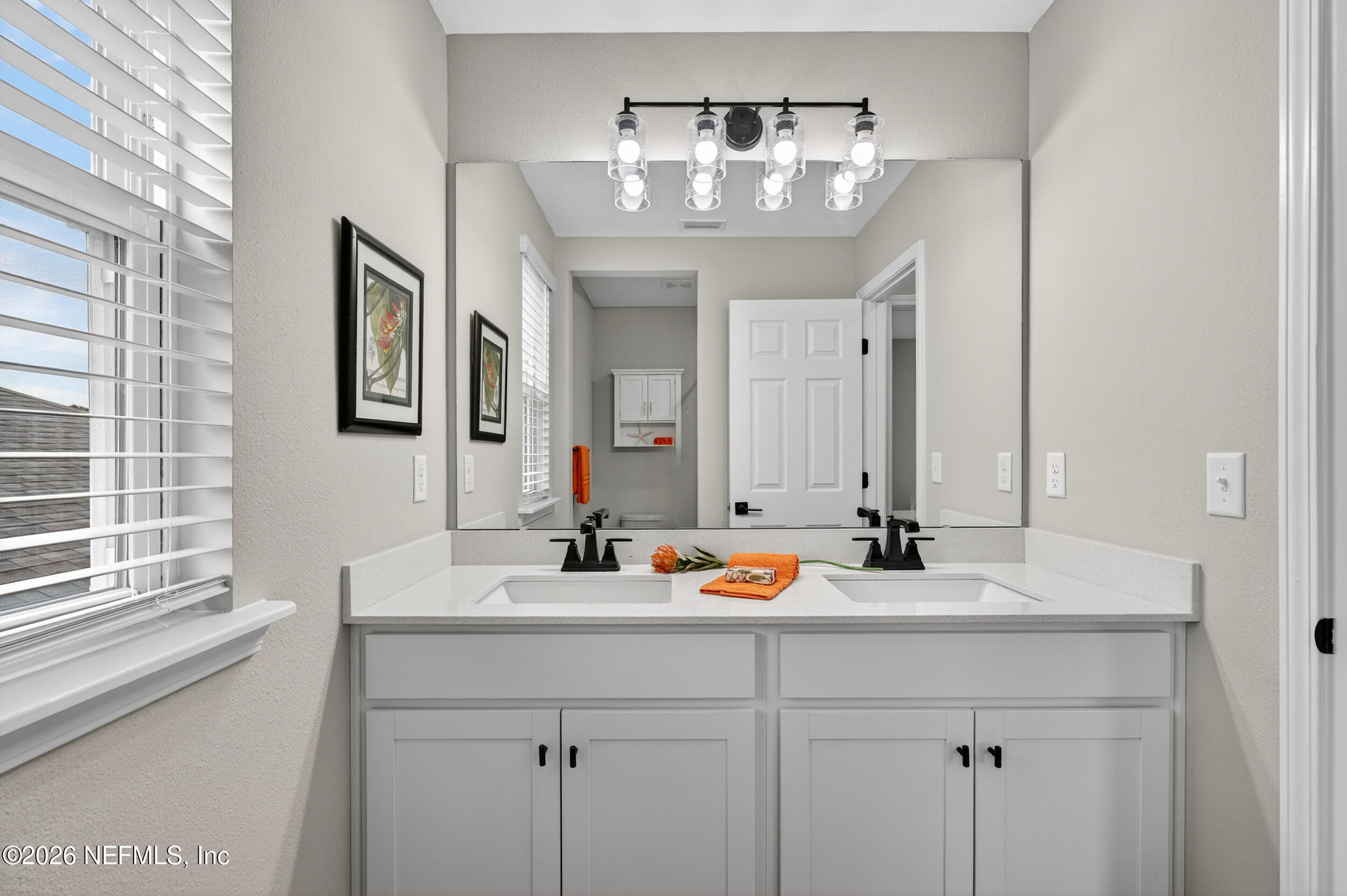57 Cedar Elm Way St. Augustine, FL 32092 - Photo 32 of 65 a bathroom with a sink and a mirror