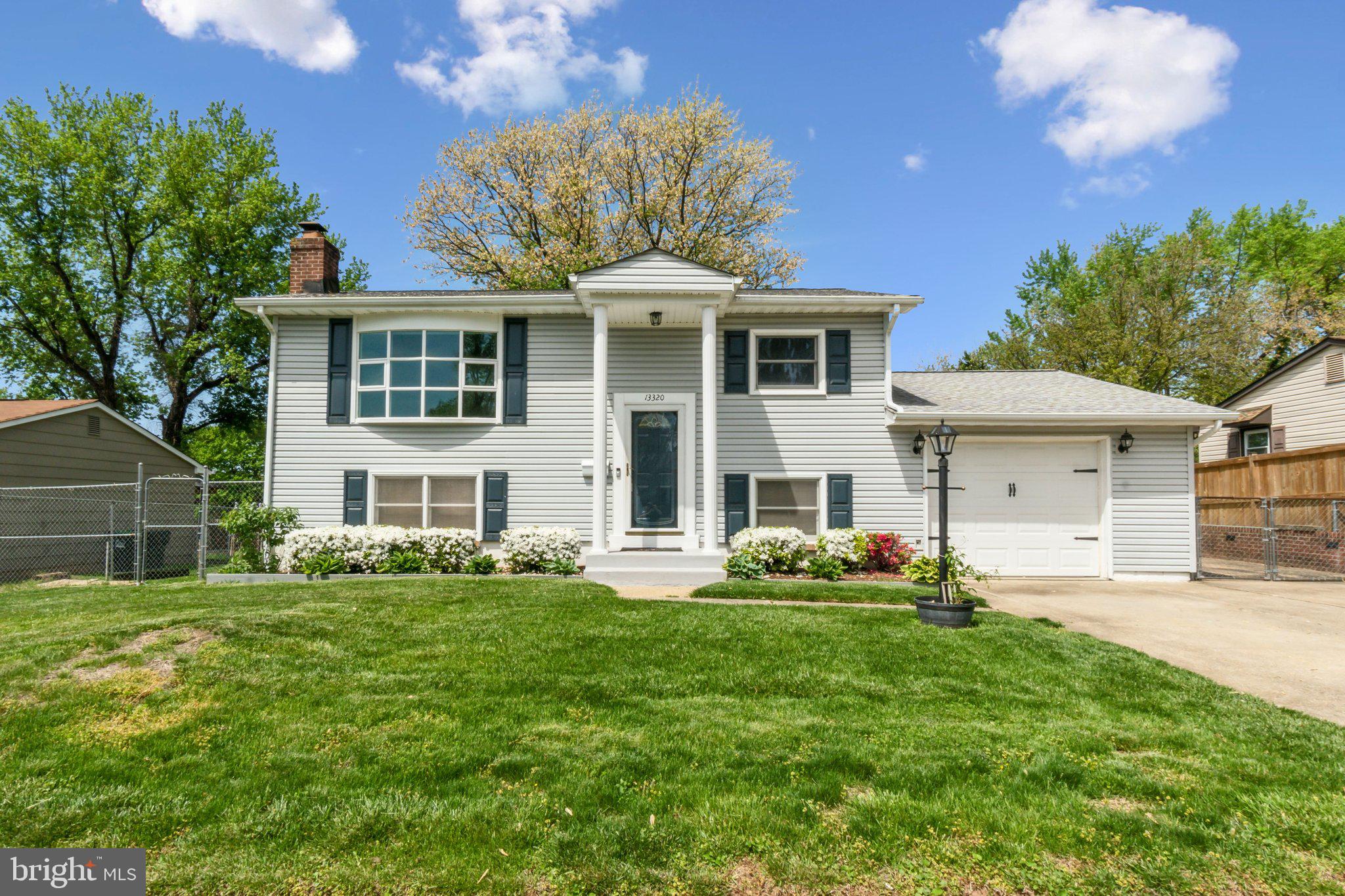 13320 Hillendale Drive Woodbridge, VA 22193 - Photo 1 of 27 a front view of a house with a garden and plants