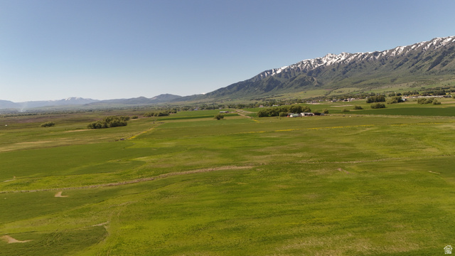 320 South 5400 West Logan, UT 84321 - Photo 33 of 42 Expansive green fields with a snow-capped mountain range backdrop