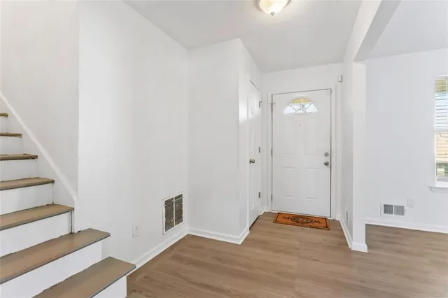 a view of empty room with wooden floor
