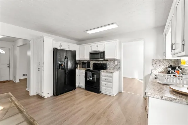 a dining room with furniture and wooden floor