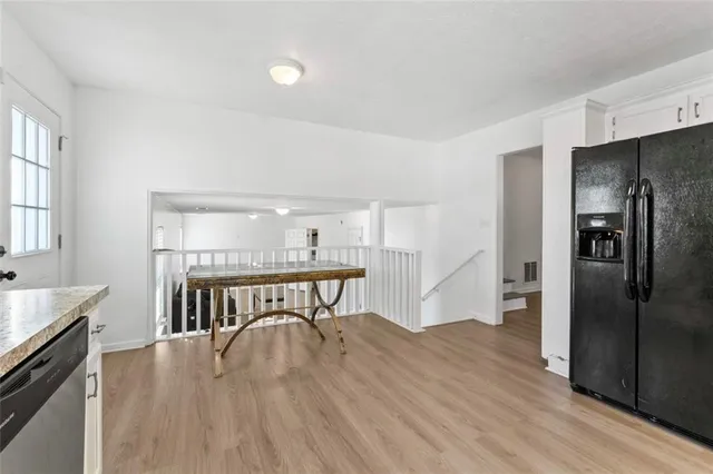 a living room with furniture and a hard wood floor