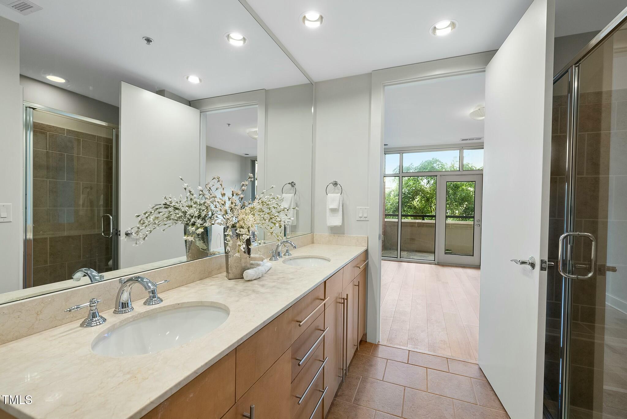 618 North Boylan Avenue, Unit 400 Raleigh, NC 27603 - Photo 11 of 28 a bathroom with a double vanity sink and a mirror