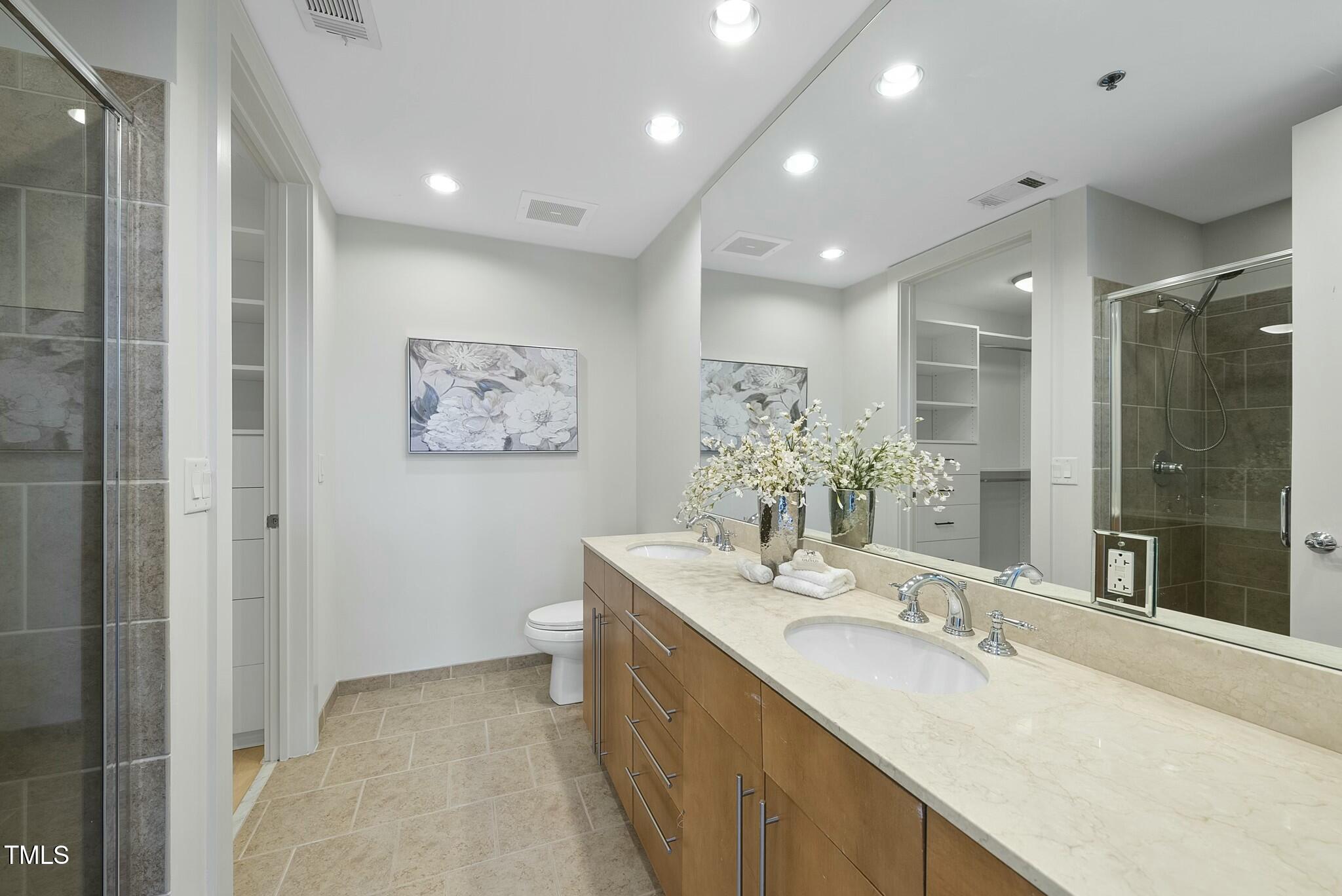 618 North Boylan Avenue, Unit 400 Raleigh, NC 27603 - Photo 12 of 28 a bathroom with a double vanity sink mirror and double