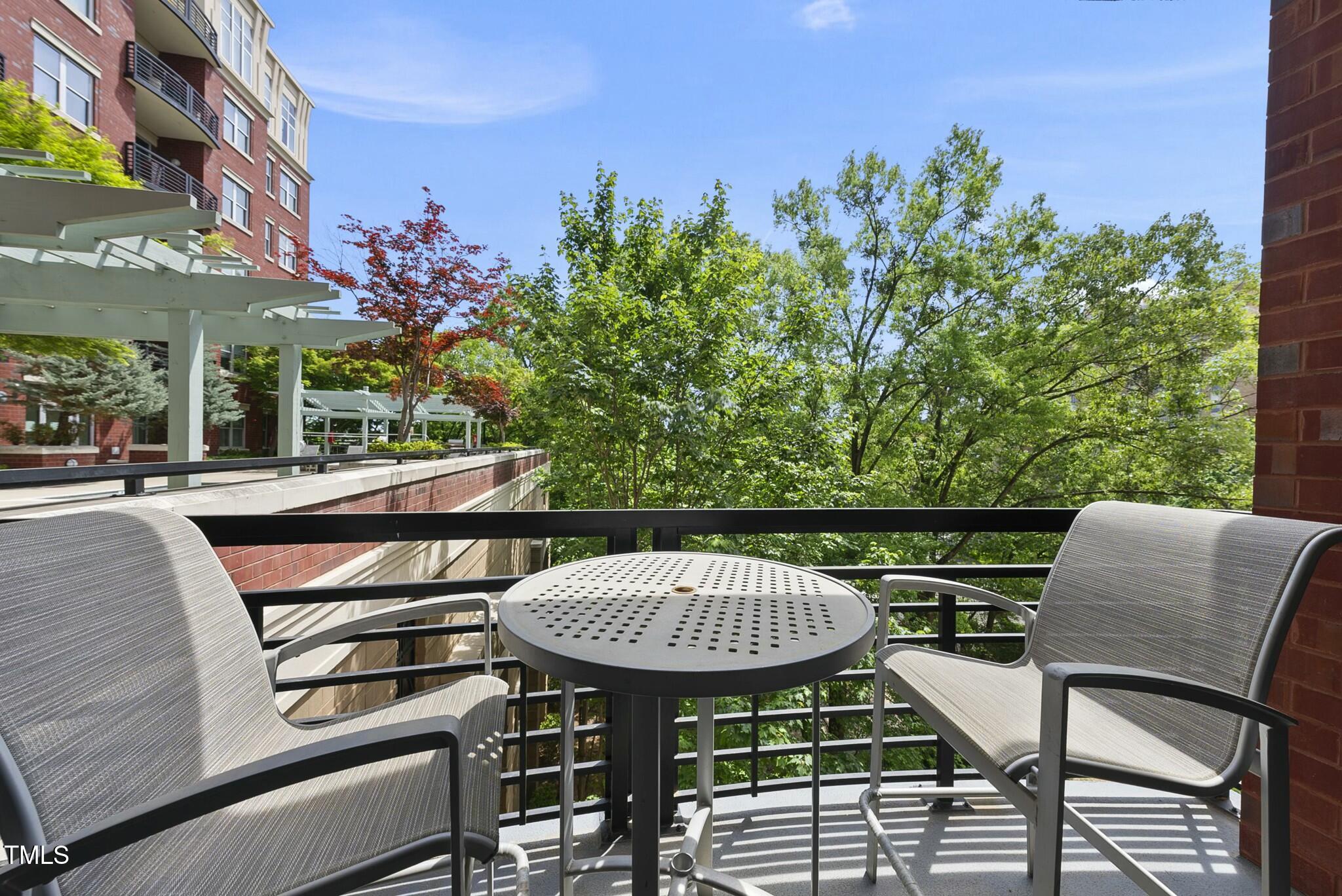 618 North Boylan Avenue, Unit 400 Raleigh, NC 27603 - Photo 17 of 28 a view of a chairs and table in the patio