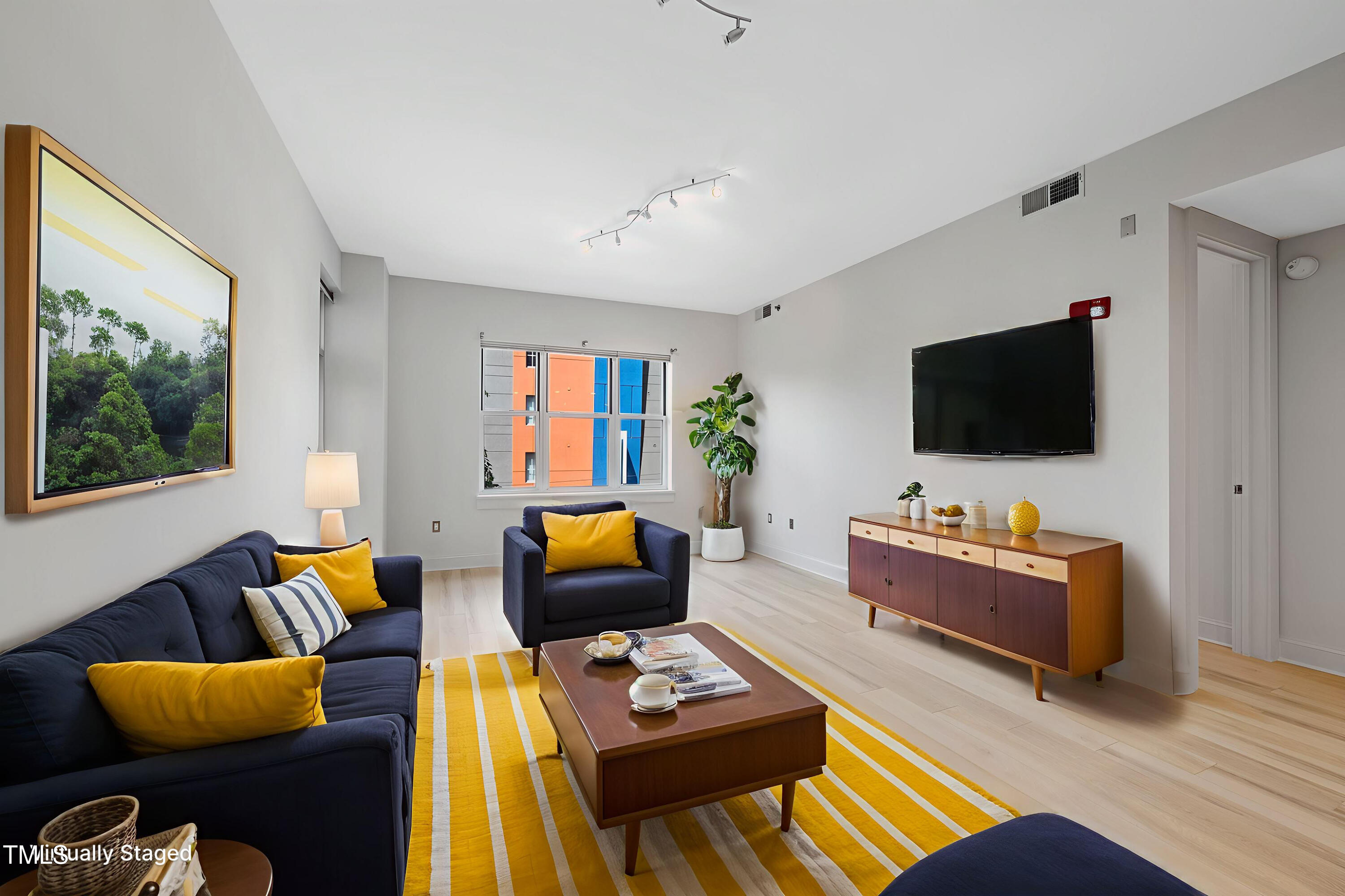 618 North Boylan Avenue, Unit 400 Raleigh, NC 27603 - Photo 2 of 28 a living room with furniture and a flat screen tv