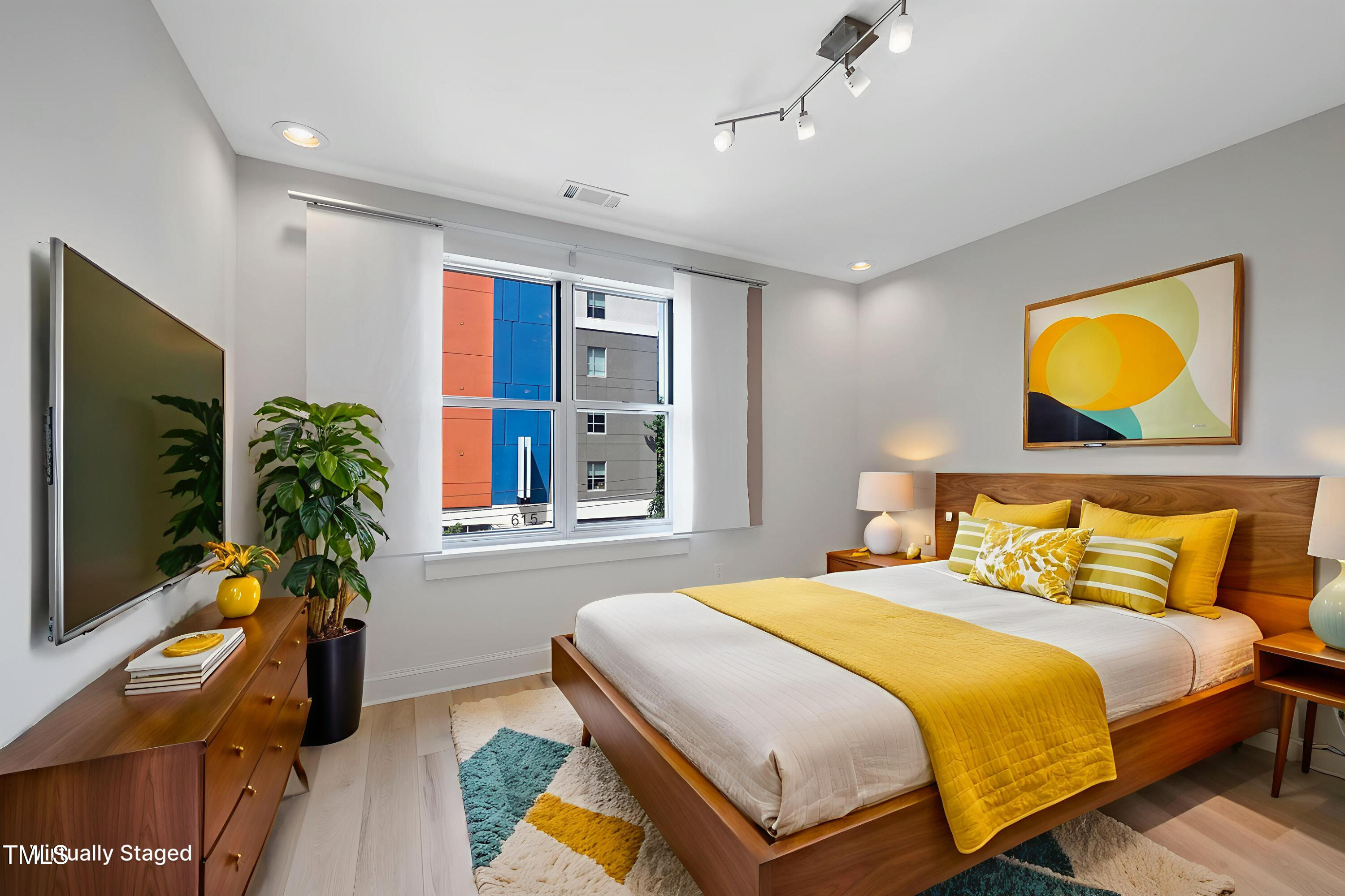 618 North Boylan Avenue, Unit 400 Raleigh, NC 27603 - Photo 3 of 28 a bedroom with a bed and a flat screen tv