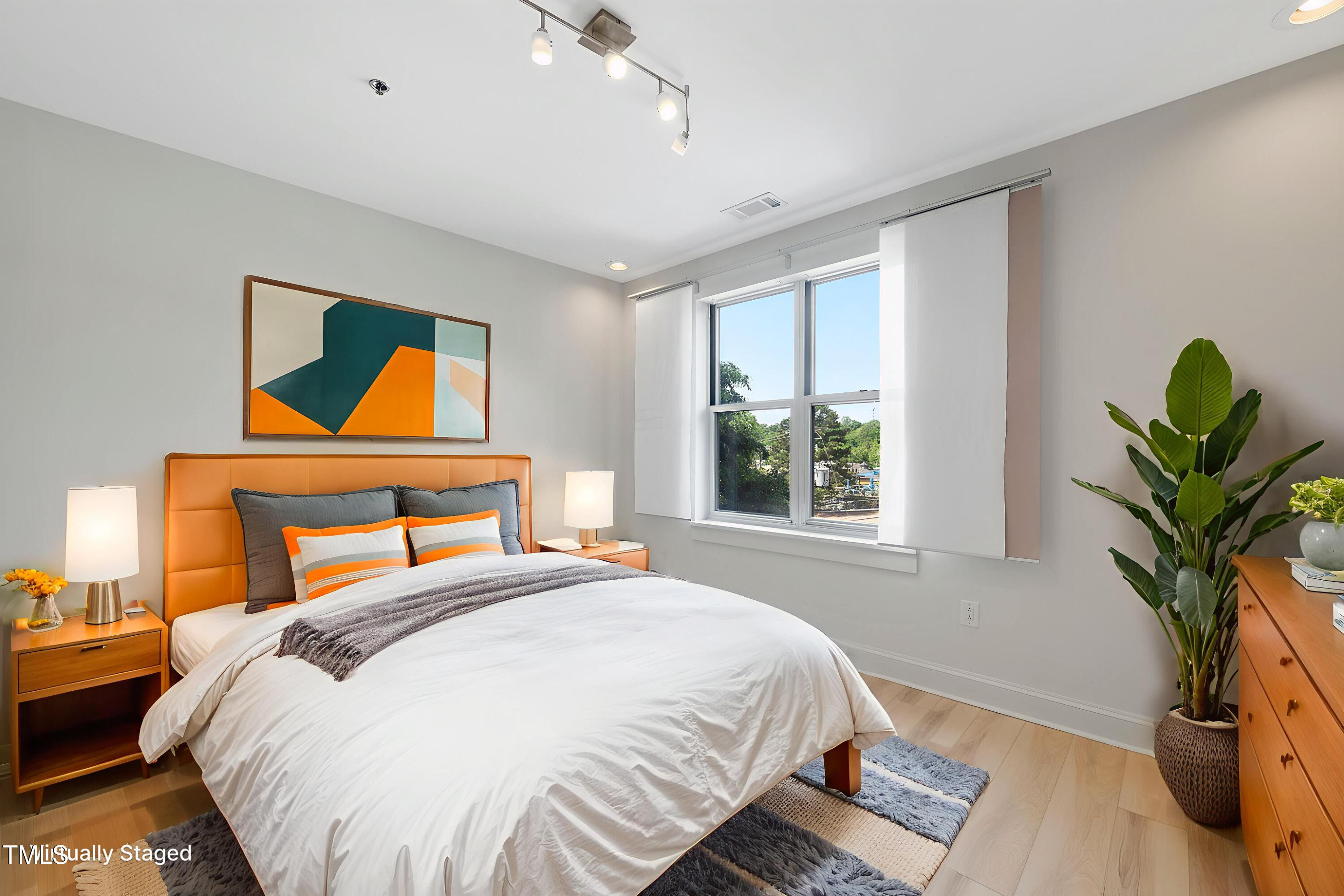 618 North Boylan Avenue, Unit 400 Raleigh, NC 27603 - Photo 4 of 28 a bedroom with a bed and a potted plant