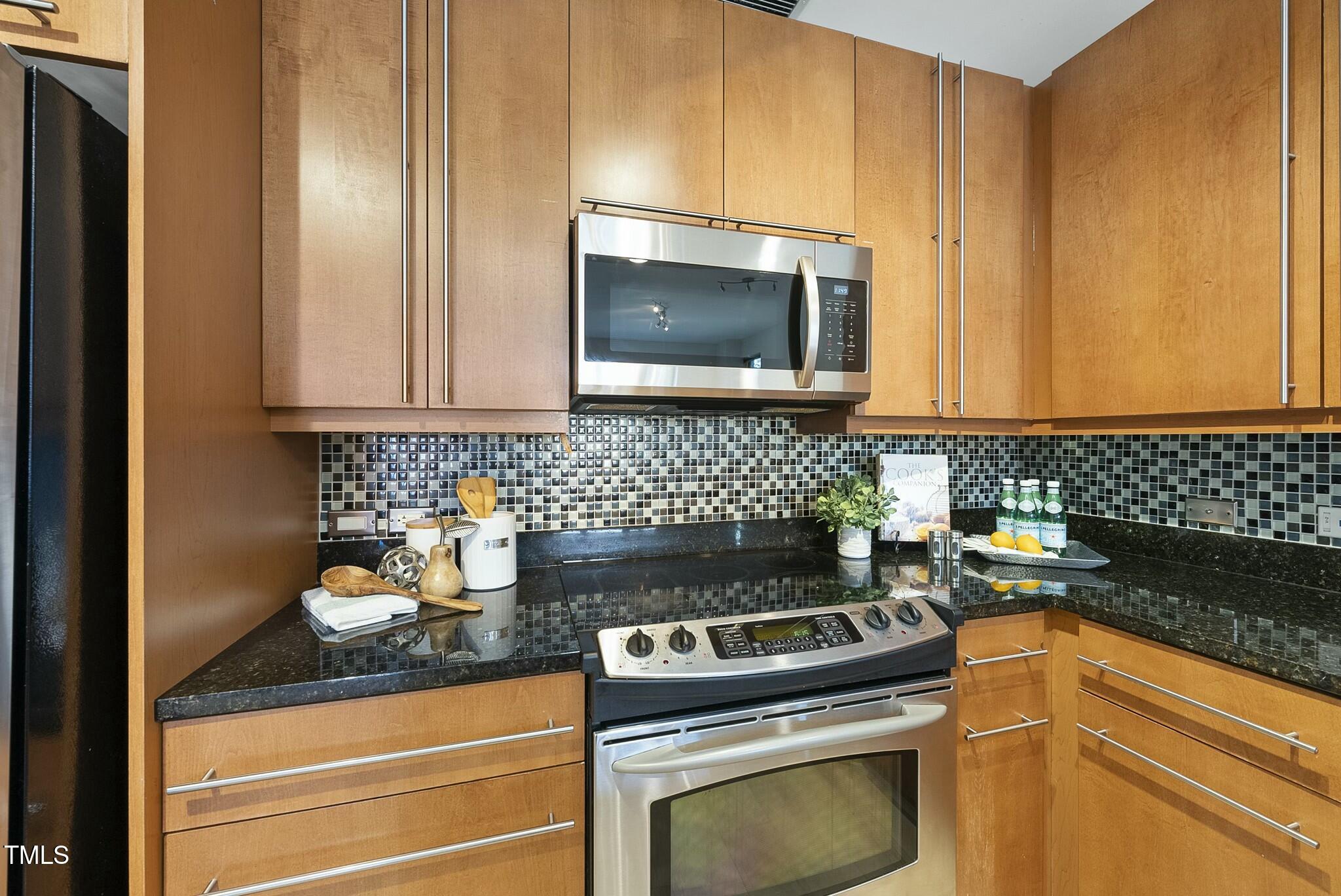 618 North Boylan Avenue, Unit 400 Raleigh, NC 27603 - Photo 8 of 28 a kitchen with a stove and a microwave