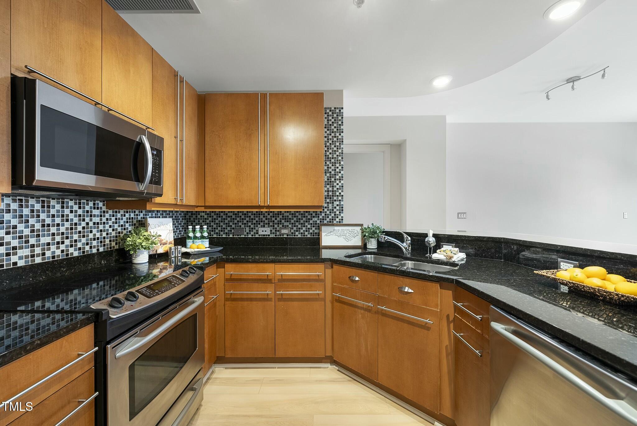 618 North Boylan Avenue, Unit 400 Raleigh, NC 27603 - Photo 9 of 28 a kitchen with a sink and cabinets