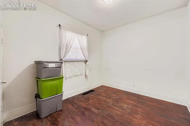 a view of a room with wooden floor