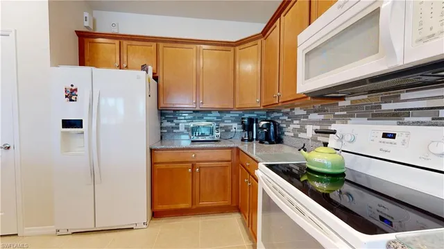 a kitchen with a refrigerator and a sink