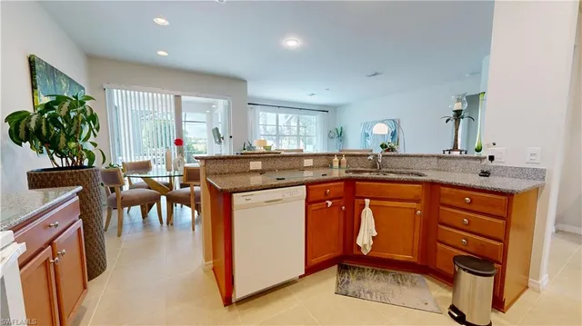 a kitchen with stainless steel appliances granite countertop sink stove and white cabinets