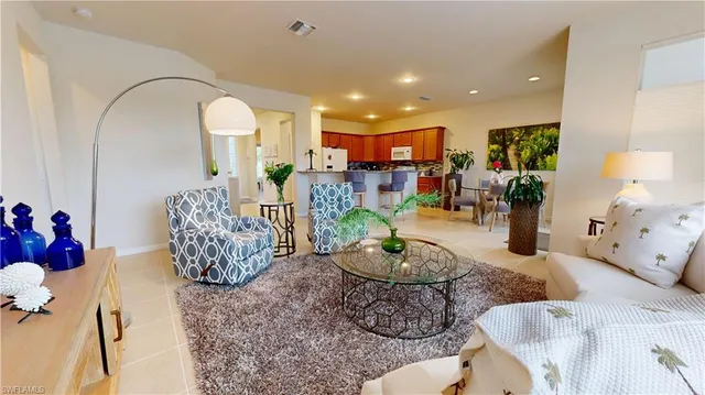 a living room with furniture chess floor and a chandelier