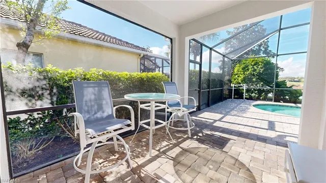 a patio with table and chairs and potted plants