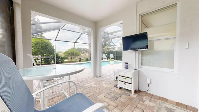 a living room with a flat screen tv and a floor to ceiling window