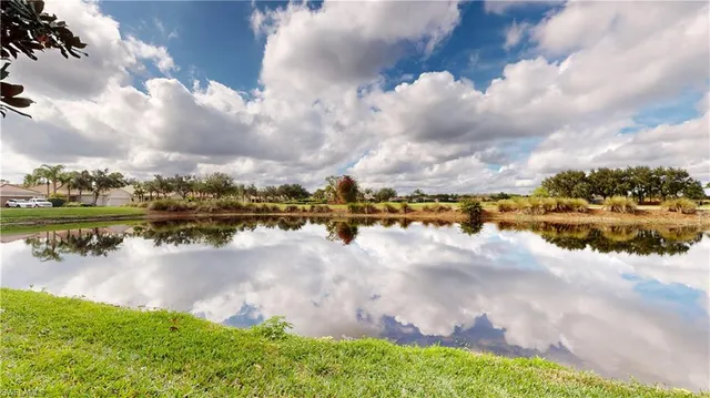 a view of a lake with houses in the back