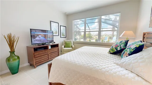 a bedroom with a bed and a potted plant