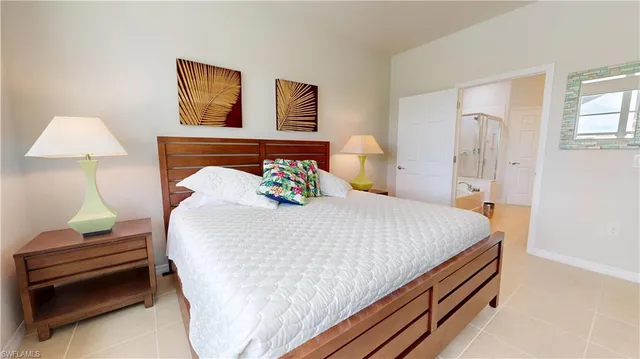 a bedroom with a bed and a lamp