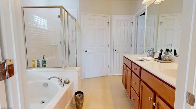 a bathroom with a tub sink and mirror