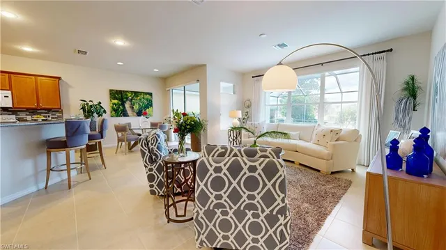 a living room with furniture chandelier and a large window