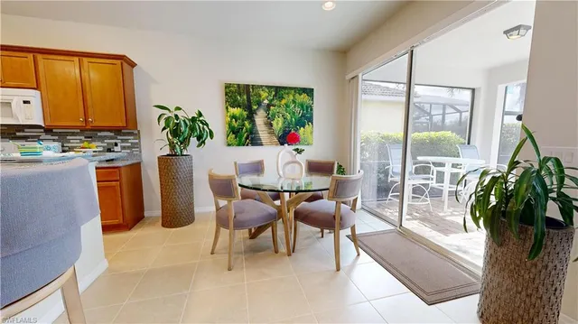 a dining room with furniture and a potted plant