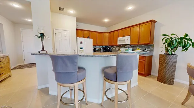 a kitchen with stainless steel appliances granite countertop a stove and a refrigerator