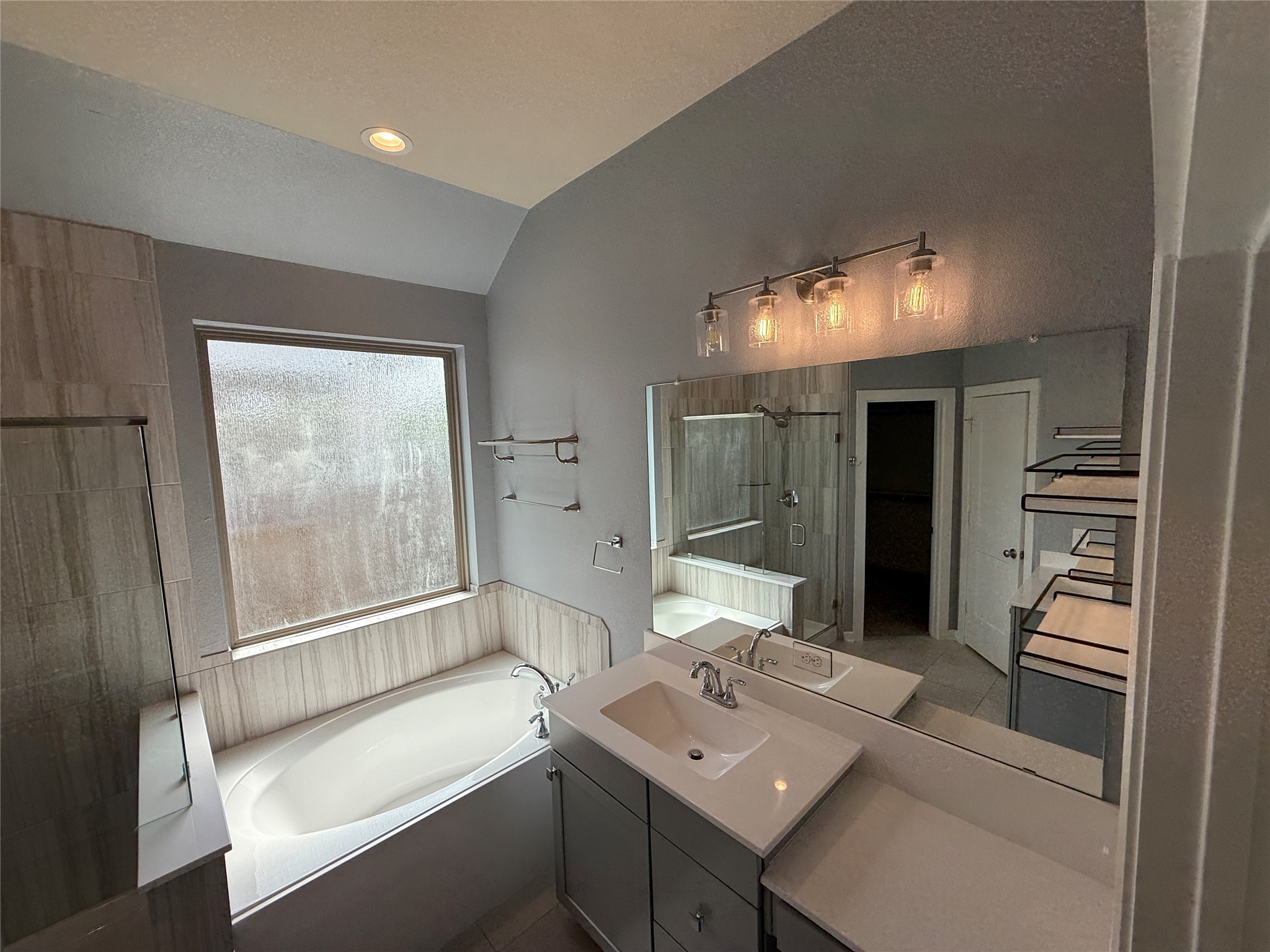 10534 Wild Chives Conroe, TX 77385 - Photo 14 of 24 a bathroom with a sink mirror and a bathtub