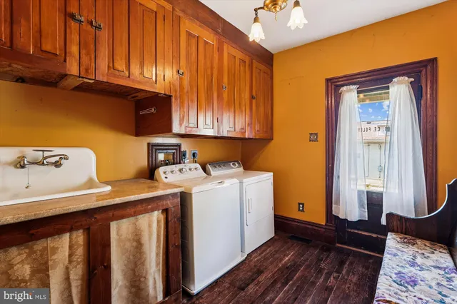 a view of a hallway with wooden floor and entryway