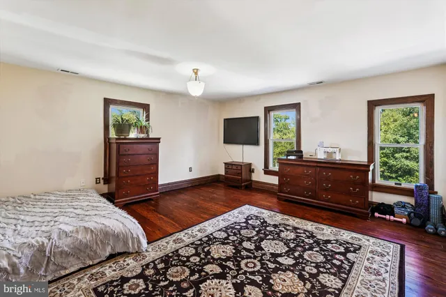 a bathroom with a granite countertop toilet sink and mirror