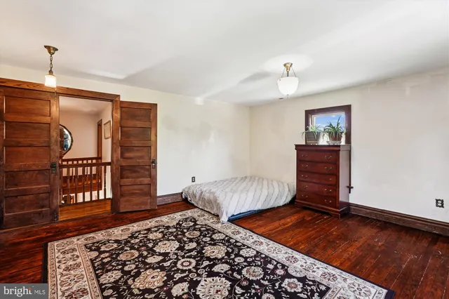 a bedroom with furniture and a rug