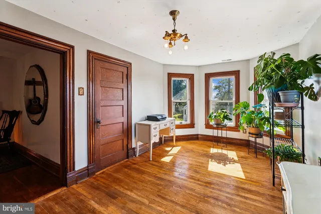a kitchen that has a stove and a wooden floor