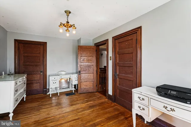 a bedroom with a bed and a dresser in it