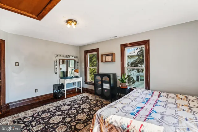 a bathroom with a granite countertop sink toilet and mirror
