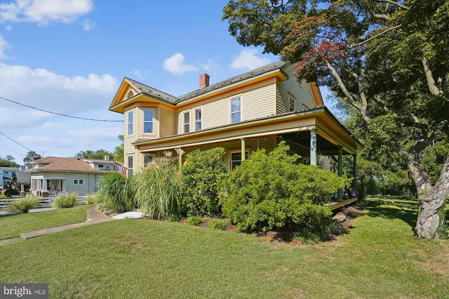 a view of entryway with wooden floor and stairs