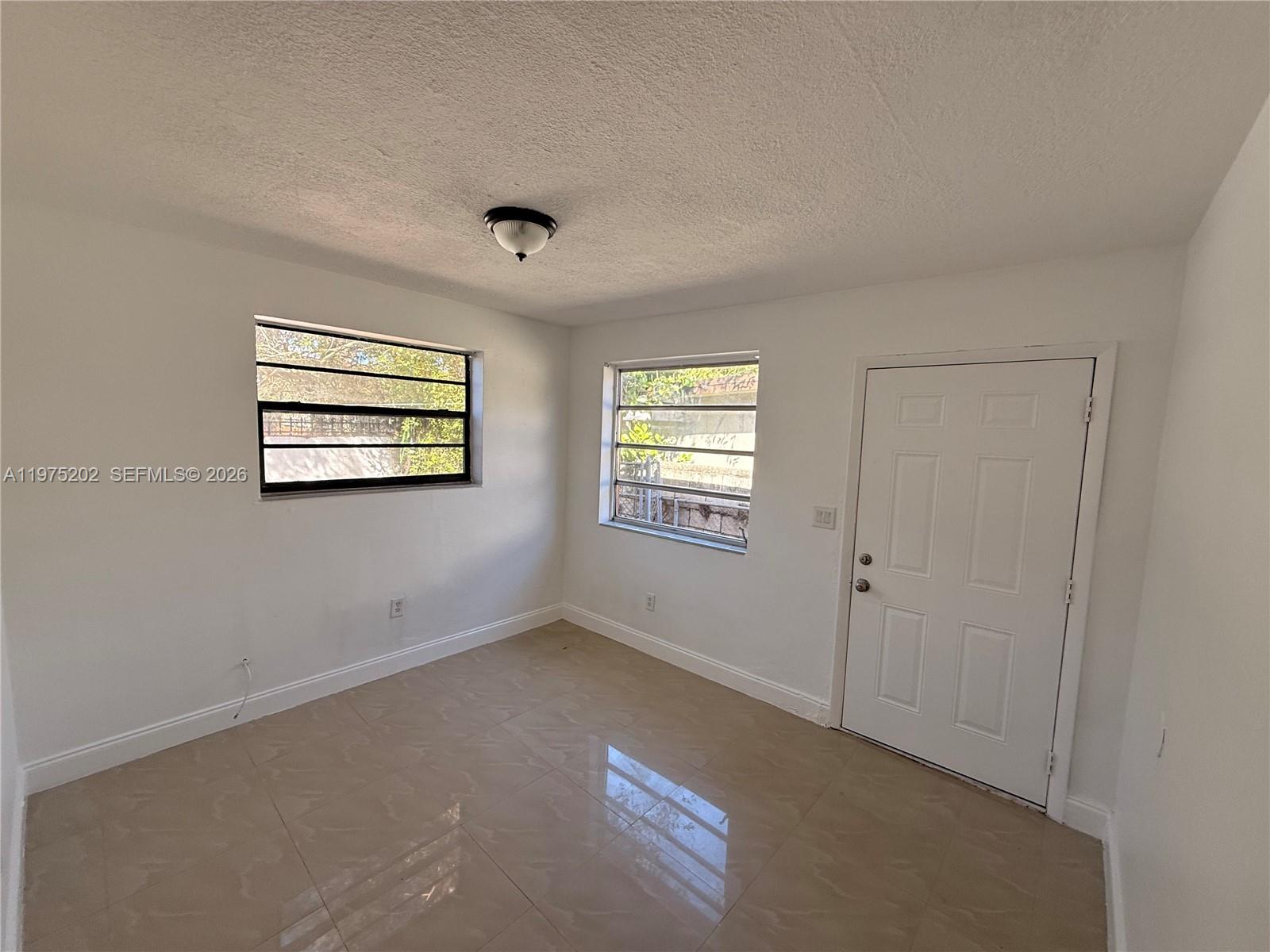 313 Northeast 57th Street, Unit 313 Miami, FL 33137 - Photo 6 of 13 a view of an empty room with a window